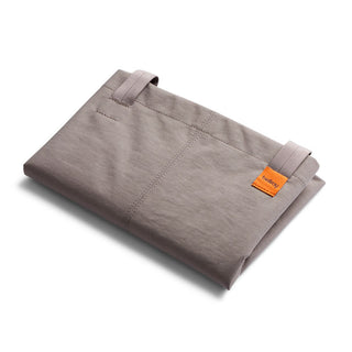 Bellroy Market Tote folded flat showing soft recycled nylon fabric with orange Bellroy brand tag