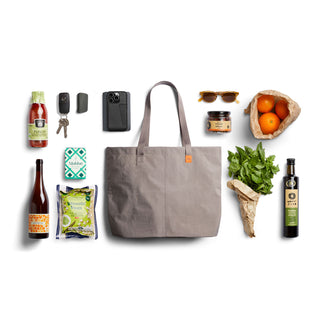 Bellroy Market Tote in taupe nylon with groceries and everyday essentials laid out beside it