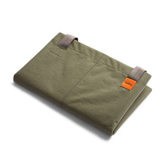 Bellroy Market Tote folded flat in olive green recycled nylon with orange brand tag detail