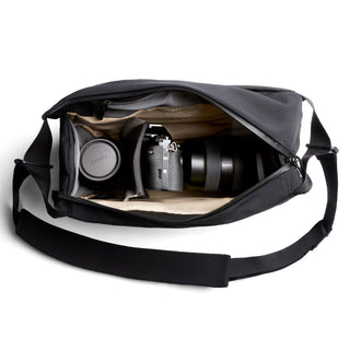 Bellroy Venture Sling 10L - Camera Edition showing organized camera gear with padded compartments and black fabric exterior