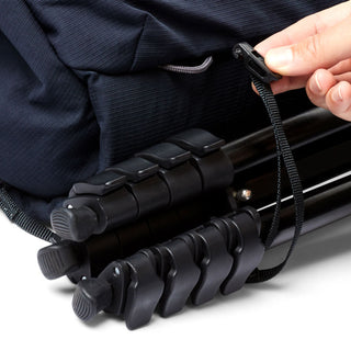 Bellroy Venture Sling 10L - Camera Edition securing black camera tripod with adjustable strap close-up