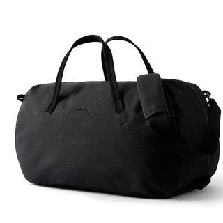 Bellroy Venture Duffel 55L in black recycled nylon with padded shoulder strap and dual carry handles