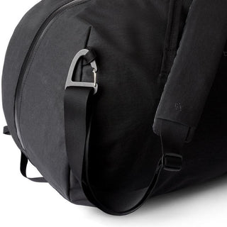 Bellroy Venture Duffel 55L black recycled fabric bag featuring adjustable padded shoulder strap and silver clip buckle