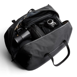 Bellroy Venture Duffel 55L in black displaying spacious interior with camera gear and organized compartments