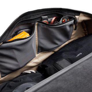 Bellroy Venture Duffel 55L interior showing organized black fabric pockets with travel essentials stored inside