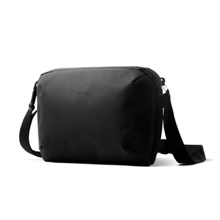 Bellroy Venture Travel Crossbody bag in black with smooth recycled fabric and adjustable strap angled view