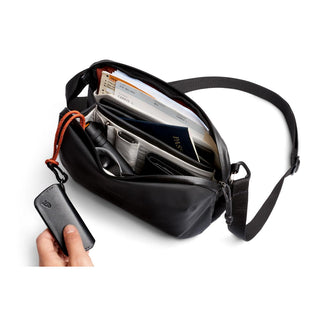Bellroy Venture Travel Crossbody bag open showing organized travel documents and accessories inside