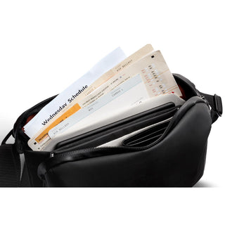Bellroy Venture Travel Crossbody in black leather with multiple compartments holding documents and cards