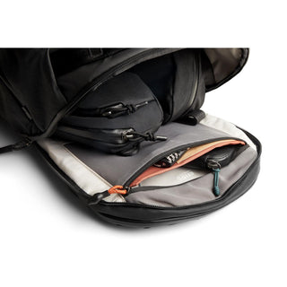 Bellroy Venture Travel Pack 26L in black showing organized interior with multiple zippered compartments and smooth fabric lining