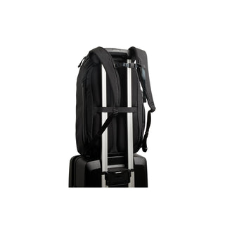 Bellroy Venture Travel Pack 26L in black secured on suitcase handle showing padded straps and attachment loop