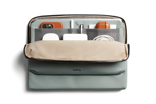 Bellroy Laptop Caddy 16" in green with beige flap organizing tech accessories and cables inside compartments