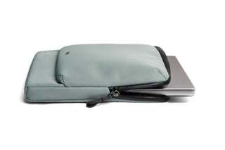 Bellroy Laptop Caddy 16 inch in muted green fabric partially open with laptop inside