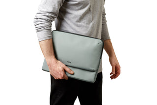 Bellroy Laptop Caddy 16" in soft grey recycled fabric held by person in casual outfit