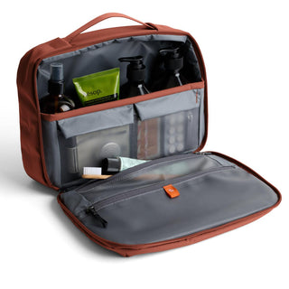 Bellroy Hanging Toiletry Kit Plus open with organized compartments and travel-sized toiletry bottles visible