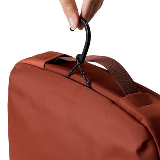 Bellroy Hanging Toiletry Kit Plus in rust fabric with black hook and sturdy carry handle close-up