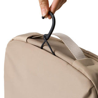 Bellroy Hanging Toiletry Kit Plus in beige fabric with black hanging hook and carrying strap