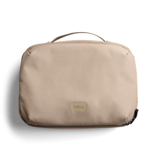 Bellroy Hanging Toiletry Kit Plus in beige with smooth recycled fabric and top carry handle