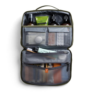 Bellroy Hanging Toiletry Kit Plus open displaying organized travel bottles and accessories with mesh compartments