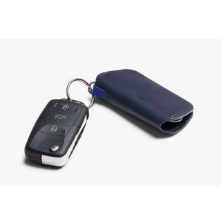Bellroy Key Cover Third Edition in navy blue leather attached to a car key fob on white background