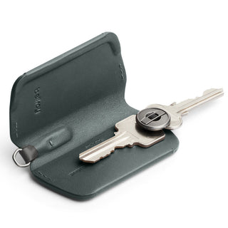 Bellroy Key Cover Third Edition in dark green leather with one silver key inside open case
