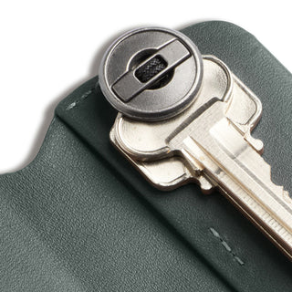 Bellroy Key Cover Third Edition in green leather holding multiple keys with metal fastener visible
