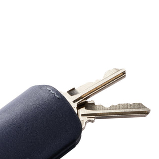 Bellroy Key Cover Plus Third Edition with navy leather wrapped around metal keys close-up view