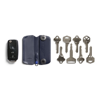 Bellroy Key Cover Plus Third Edition in navy leather with metal fasteners and multiple keys displayed outside