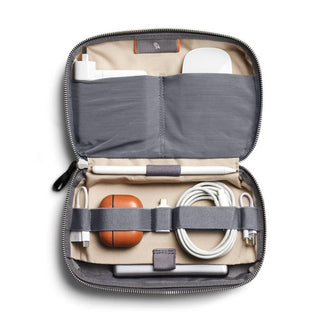 Bellroy Tech Kit open showing organized charging cables and accessories in grey recycled fabric interior