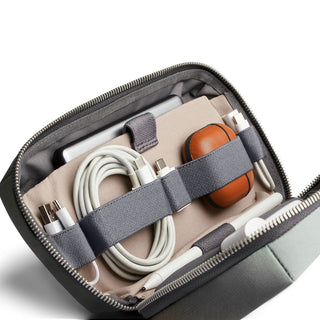 Bellroy Tech Kit with organized cables and earbuds inside recycled fabric case with zipper closure