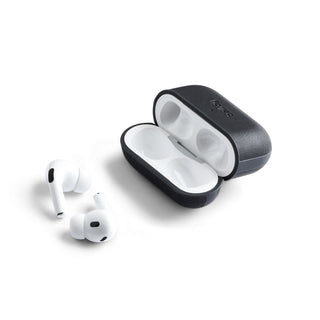 Bellroy Pod Jacket Pro 2nd Generation black eco-leather case with AirPods Pro lying beside it on white background