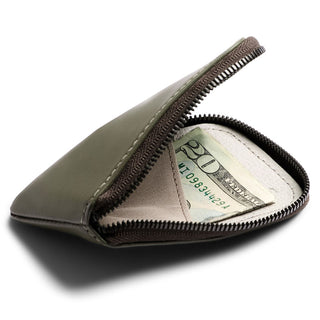 Bellroy Card Pocket in olive leather with zipper partially open showing cash inside pouch