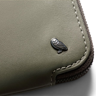 Bellroy Card Pocket in olive green leather with owl logo and detailed stitching close-up