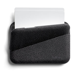 Bellroy Flip Case Second Edition in black textured leather holding white cards from top angle view