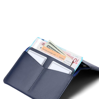 Bellroy Passport Cover in dark blue leather displaying card slots and currency storage compartments