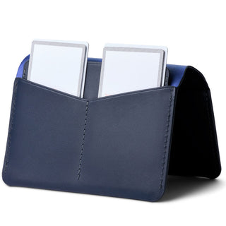 Bellroy Passport Cover in navy leather with dual card slots shown holding white cards