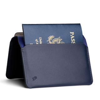 Bellroy Passport Cover in navy leather holding a partially visible United States passport