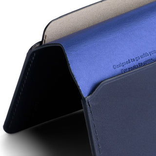 Bellroy Passport Cover showing smooth blue leather interior and navy exterior with embossed text detail