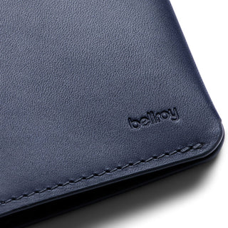 Bellroy Passport Cover in navy leather with subtle embossed logo and detailed stitching close-up