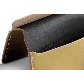 Bellroy Under Cover card sleeve in tan leather showing folded edges and smooth black interior lining