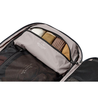 Bellroy Lite Travel Pack 38L open showing organized compartment with folded clothes in neutral tones