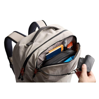 Bellroy Lite Travel Pack 38L in light beige showing organized front pocket with travel essentials inside