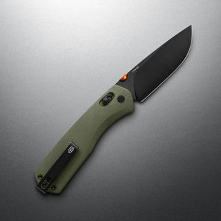 James The Carter XL Knife with textured green Micarta handle and black VG-10 steel blade angled on gray surface