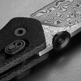 James The Carter Knife close-up showing Damascus VG-10 steel blade and textured black Micarta handle