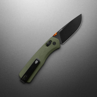 James The Carter Knife with textured olive green Micarta handle and black coated VG-10 blade displayed on gray background