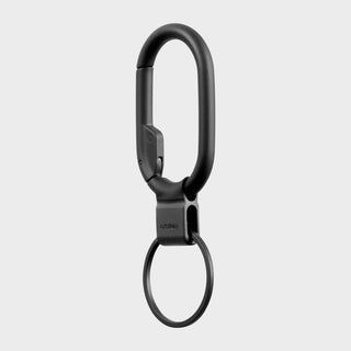 Orbitkey Clip Mini black metal carabiner with quick-release keyring hanging vertically on gray background