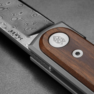 James The Duval Knife with rosewood handle and detailed patterned steel blade close-up