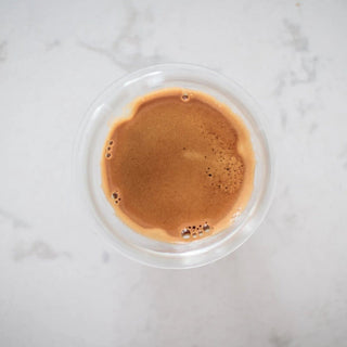 KRUVE PROPEL Espresso Glasses (75ml/2.5oz) (2-Pack) showing top view of espresso crema in clear glass