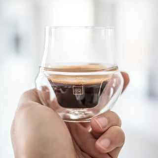 KRUVE PROPEL Espresso Glasses (75ml/2.5oz) (2-Pack) held showing double-wall borosilicate design