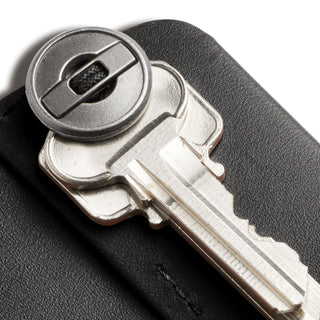 Bellroy Key Cover Third Edition black leather key organizer holding silver keys with visible stitching detail