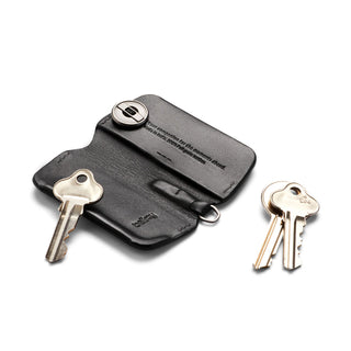 Bellroy Key Cover Third Edition in black leather with metal fastening and separated keys on white background